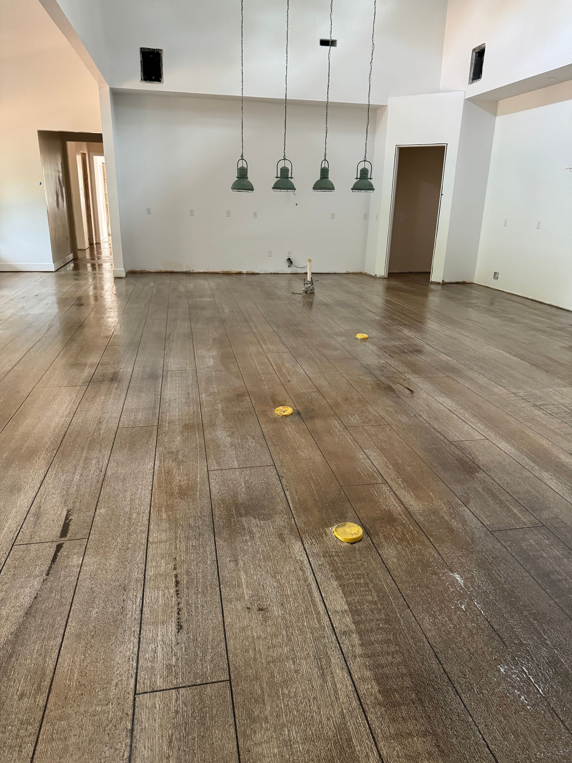 An empty room with a wooden floor and white walls