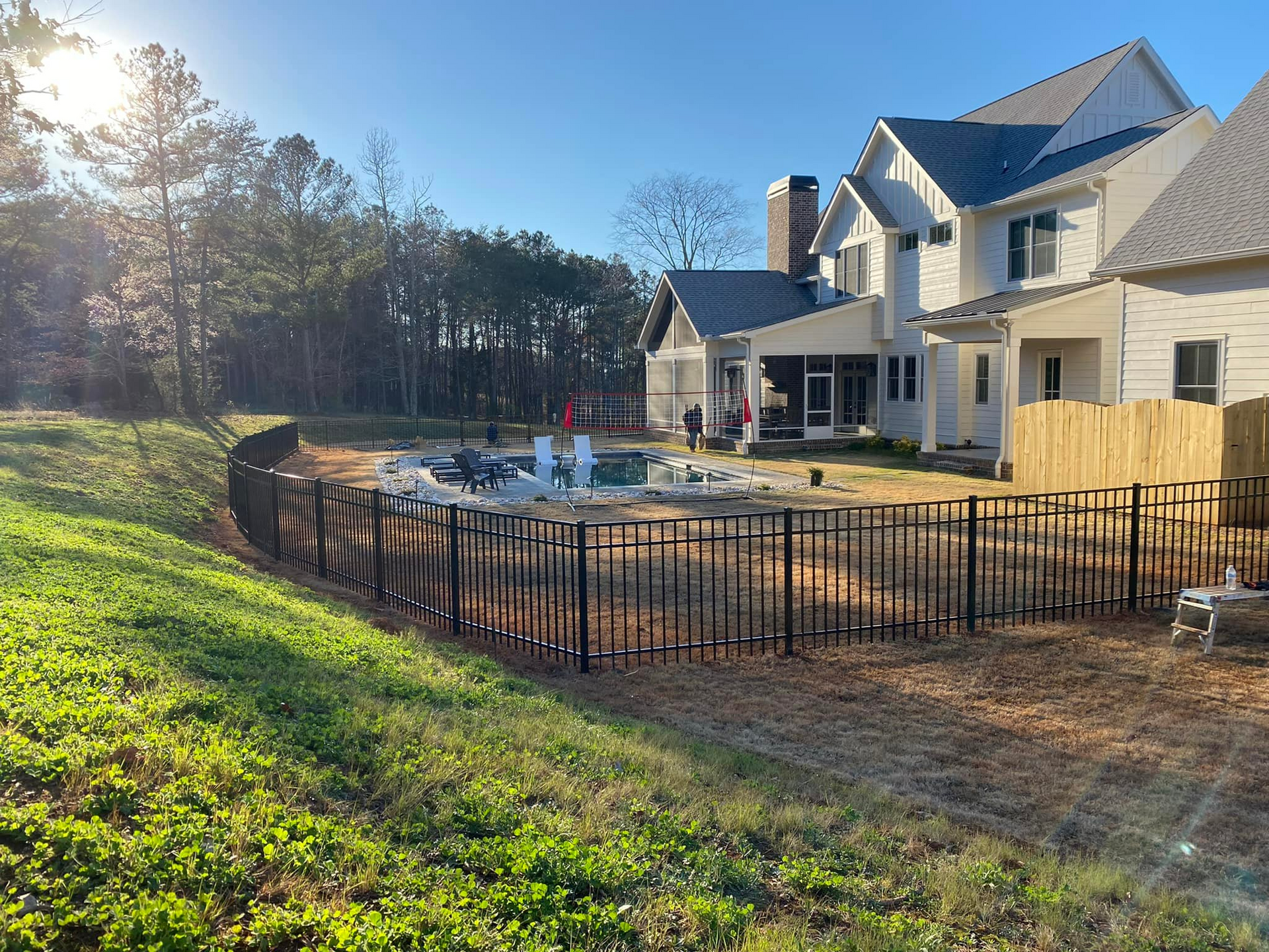 A large house with a fence in front of it is being built.