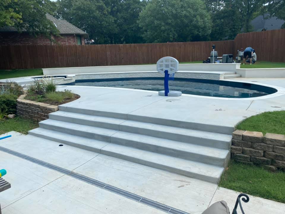 There is a basketball hoop in the middle of the pool.