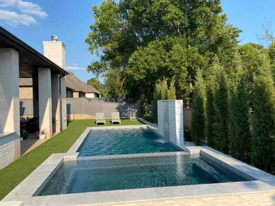 A large swimming pool in the backyard of a house