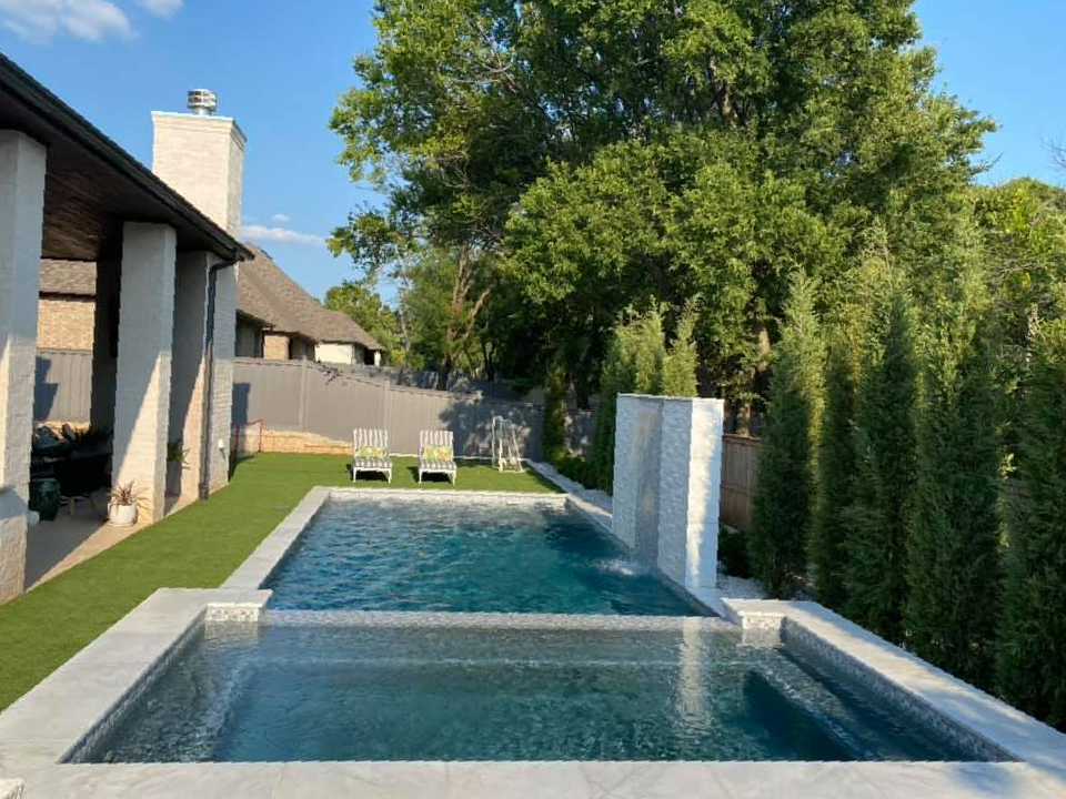 A large swimming pool in the backyard of a house