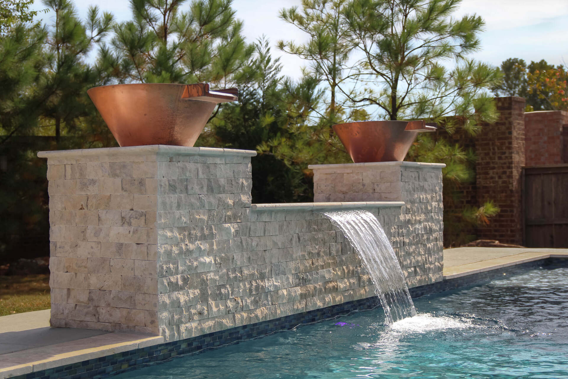 A swimming pool with a waterfall in the middle of it