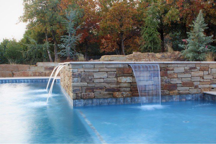 There is a waterfall in the middle of the pool.