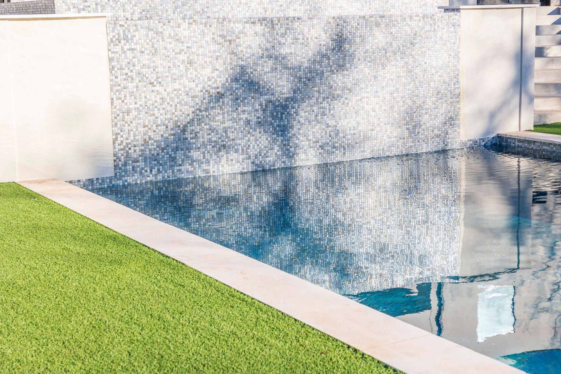 There is a waterfall in the middle of the pool.