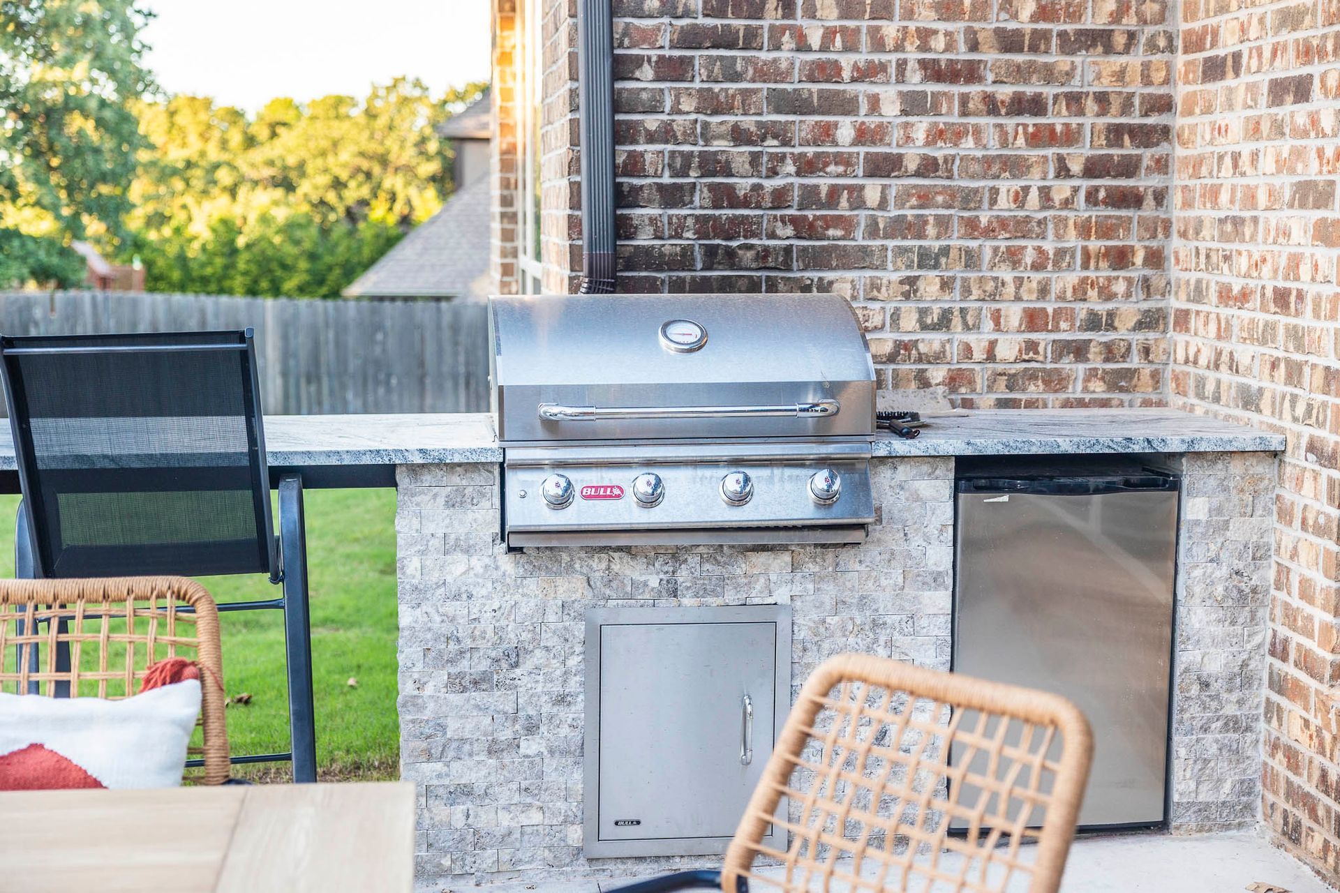 There is a grill and a dishwasher in the backyard.