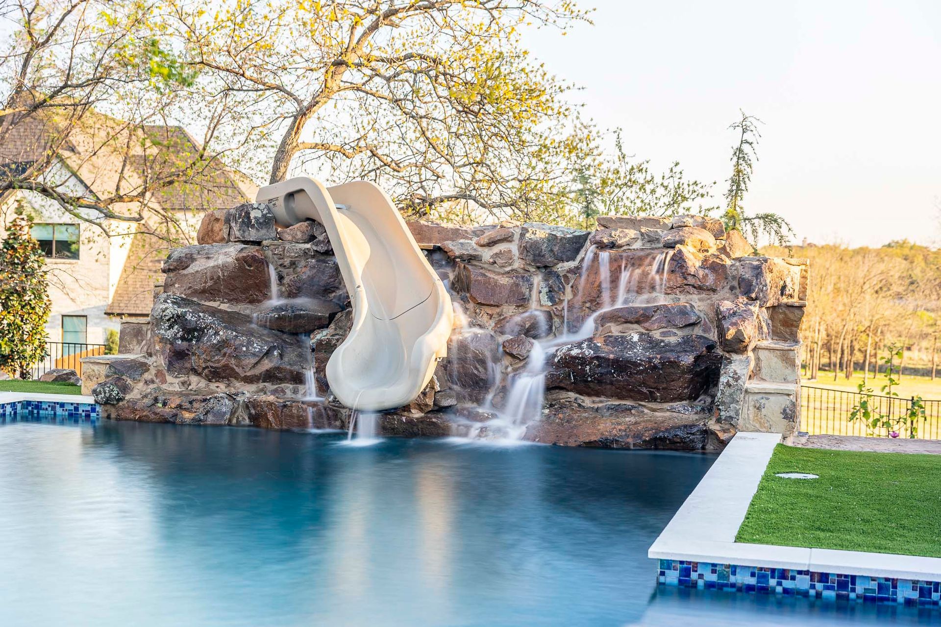 There is a water slide in the middle of the pool.