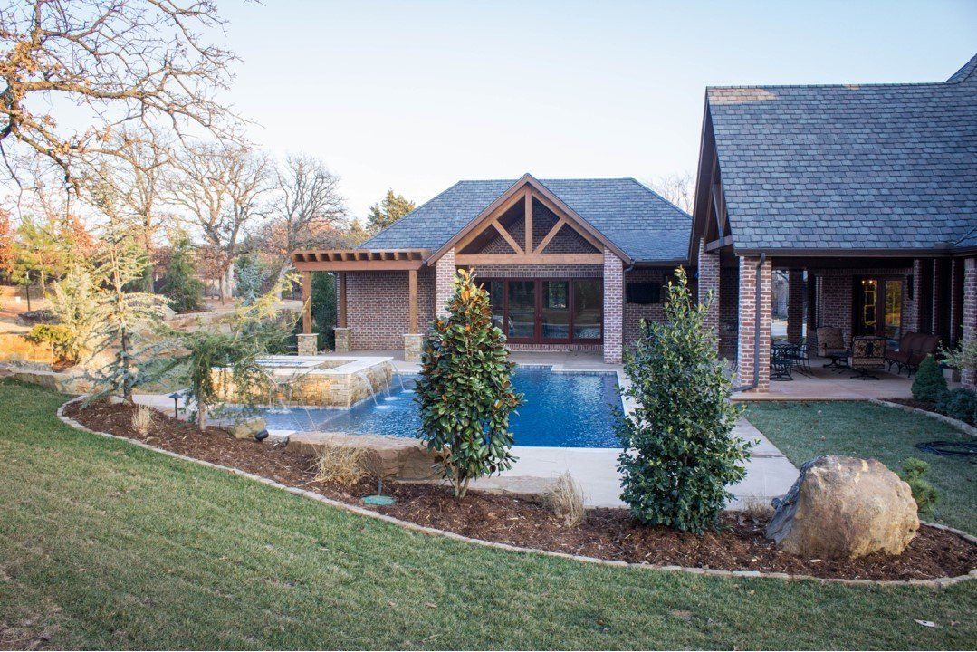A large house with a large swimming pool in the backyard.
