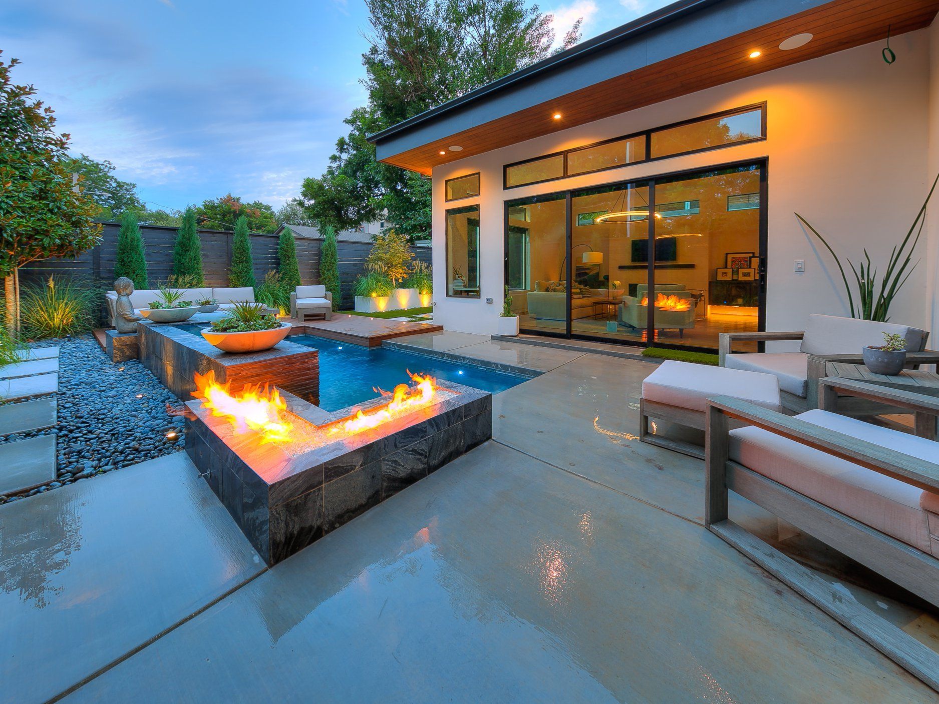 There is a fire pit in the backyard of a house.