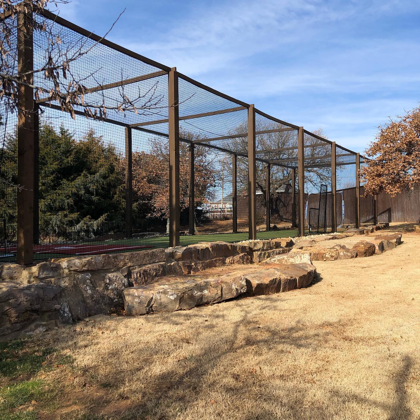 A fence with a few trees in the background