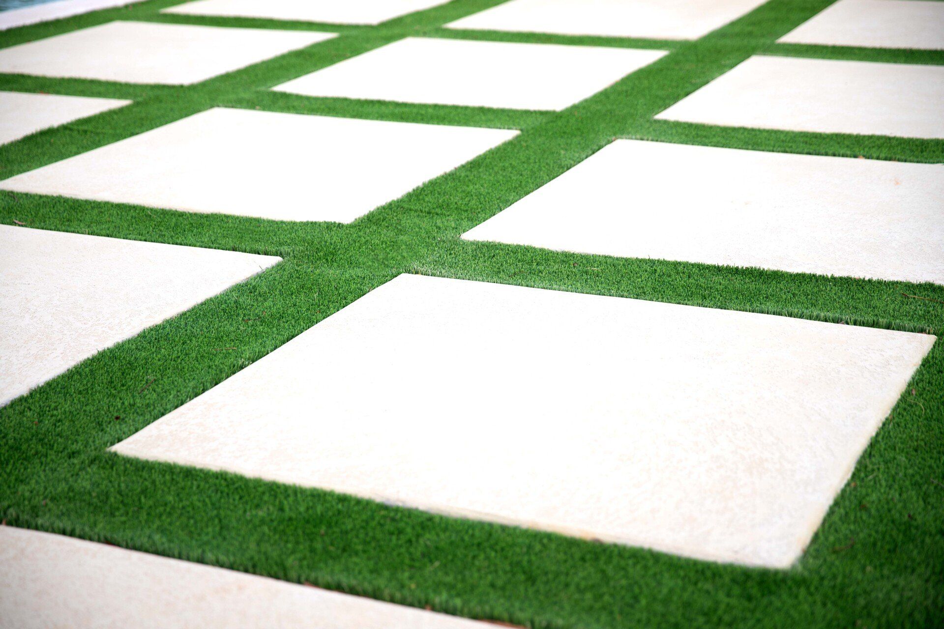 A close up of a lawn with white squares and green grass.