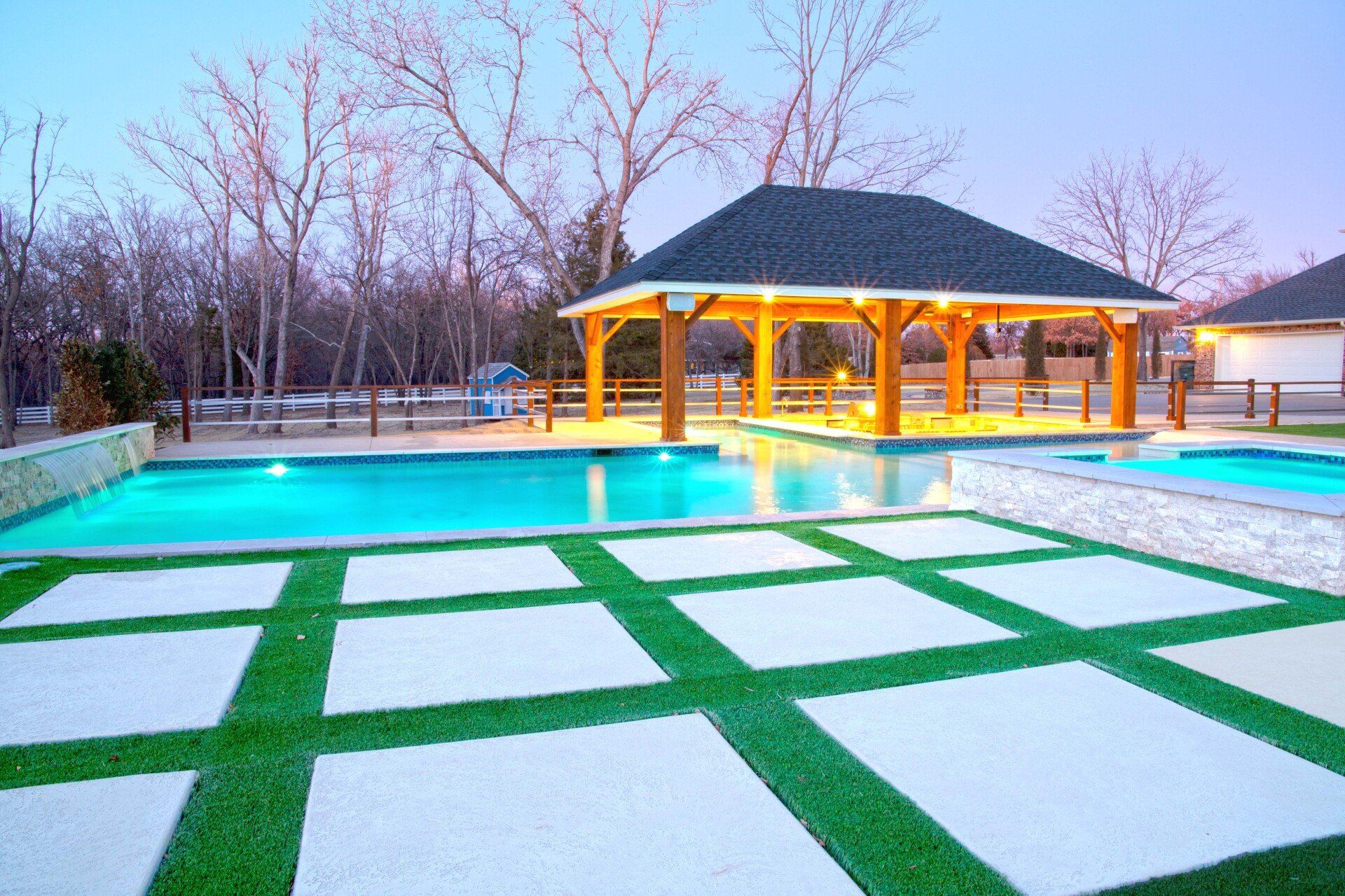 A large swimming pool with a gazebo in the background.