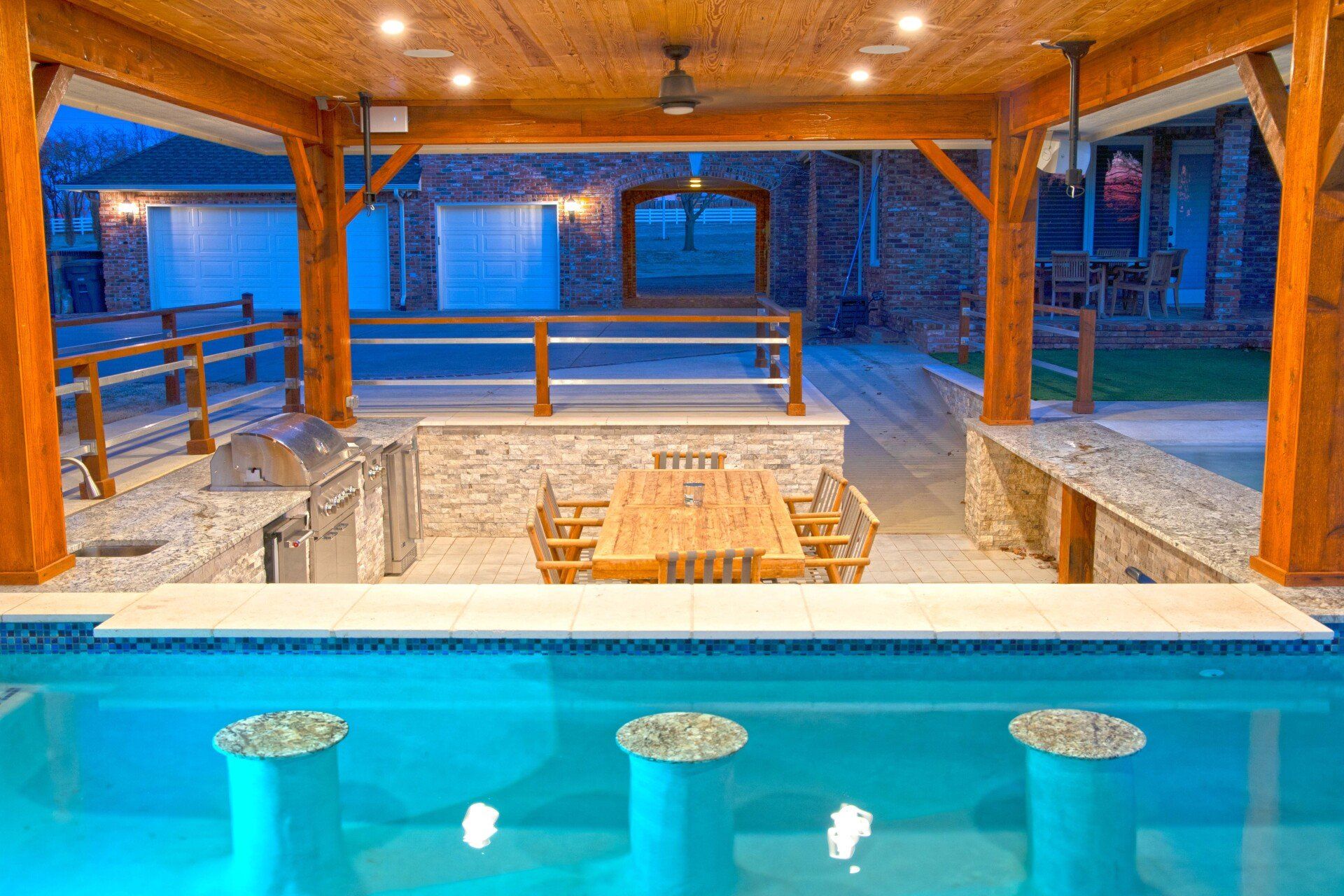 A large swimming pool with a table and chairs in the middle of it.