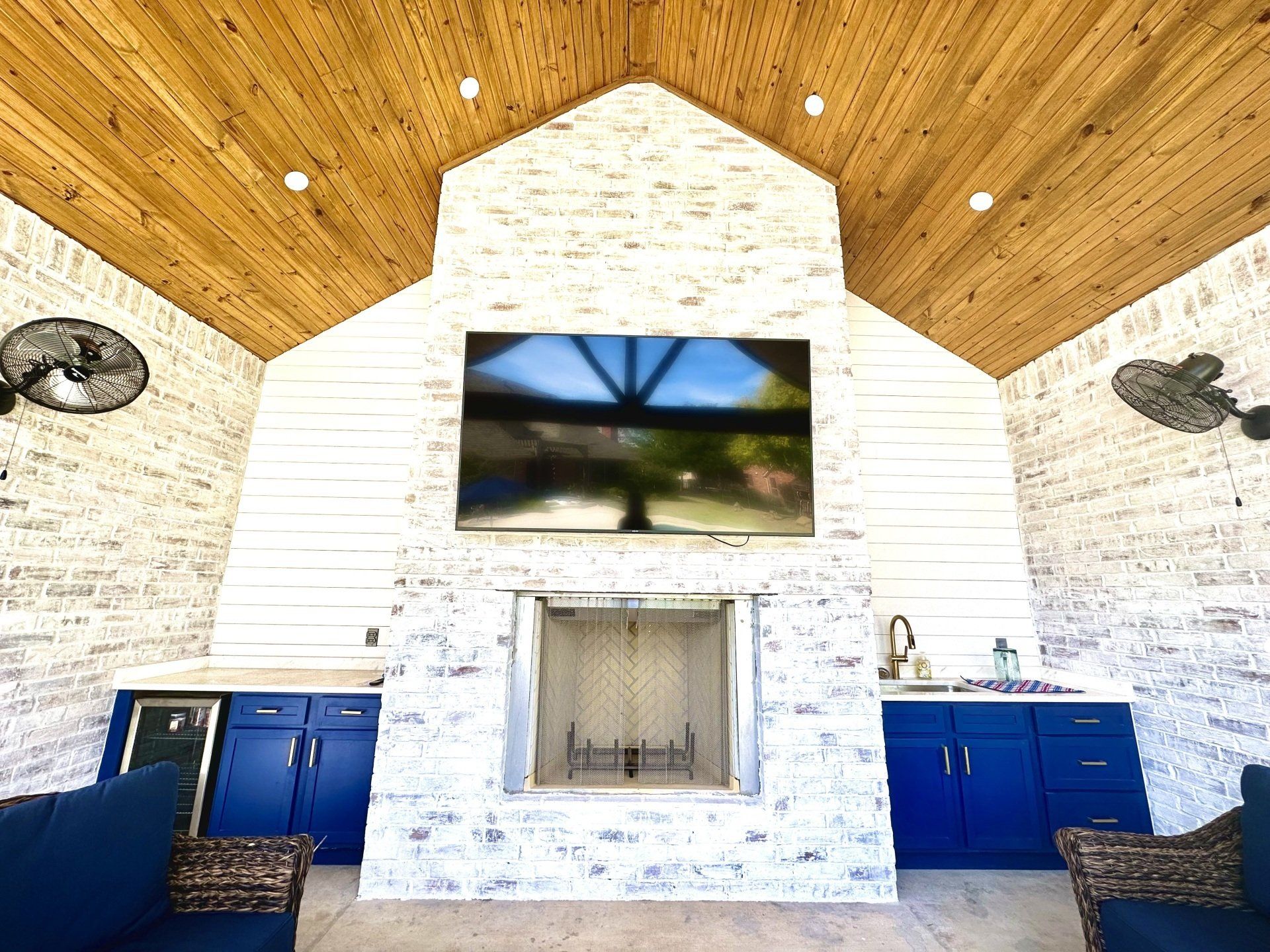 A living room with a fireplace and a flat screen tv on the wall.