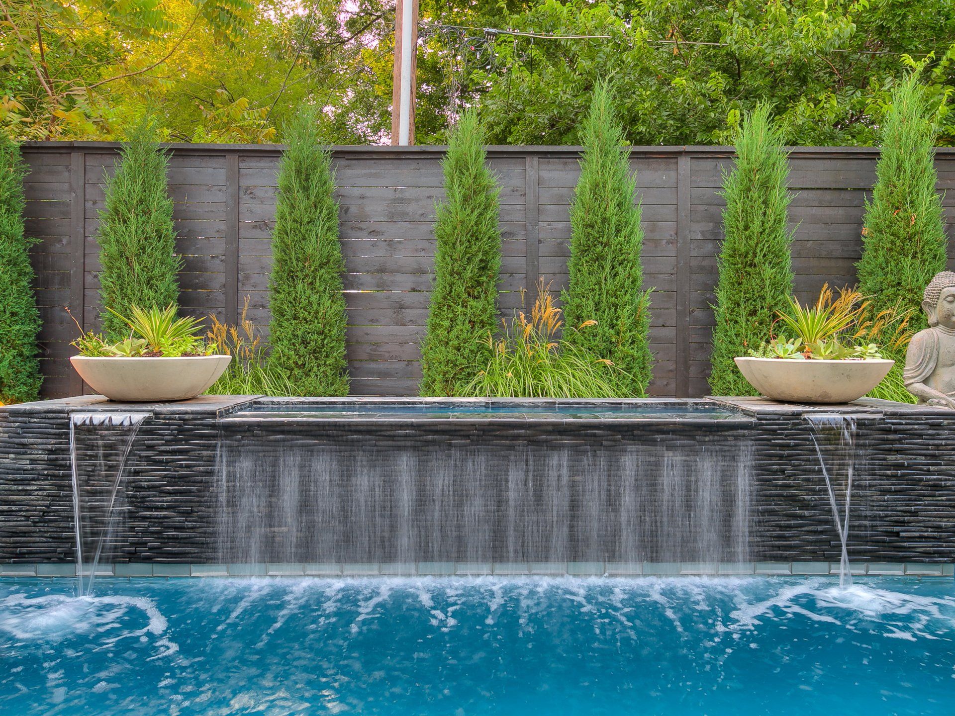 There is a waterfall in the middle of the pool.