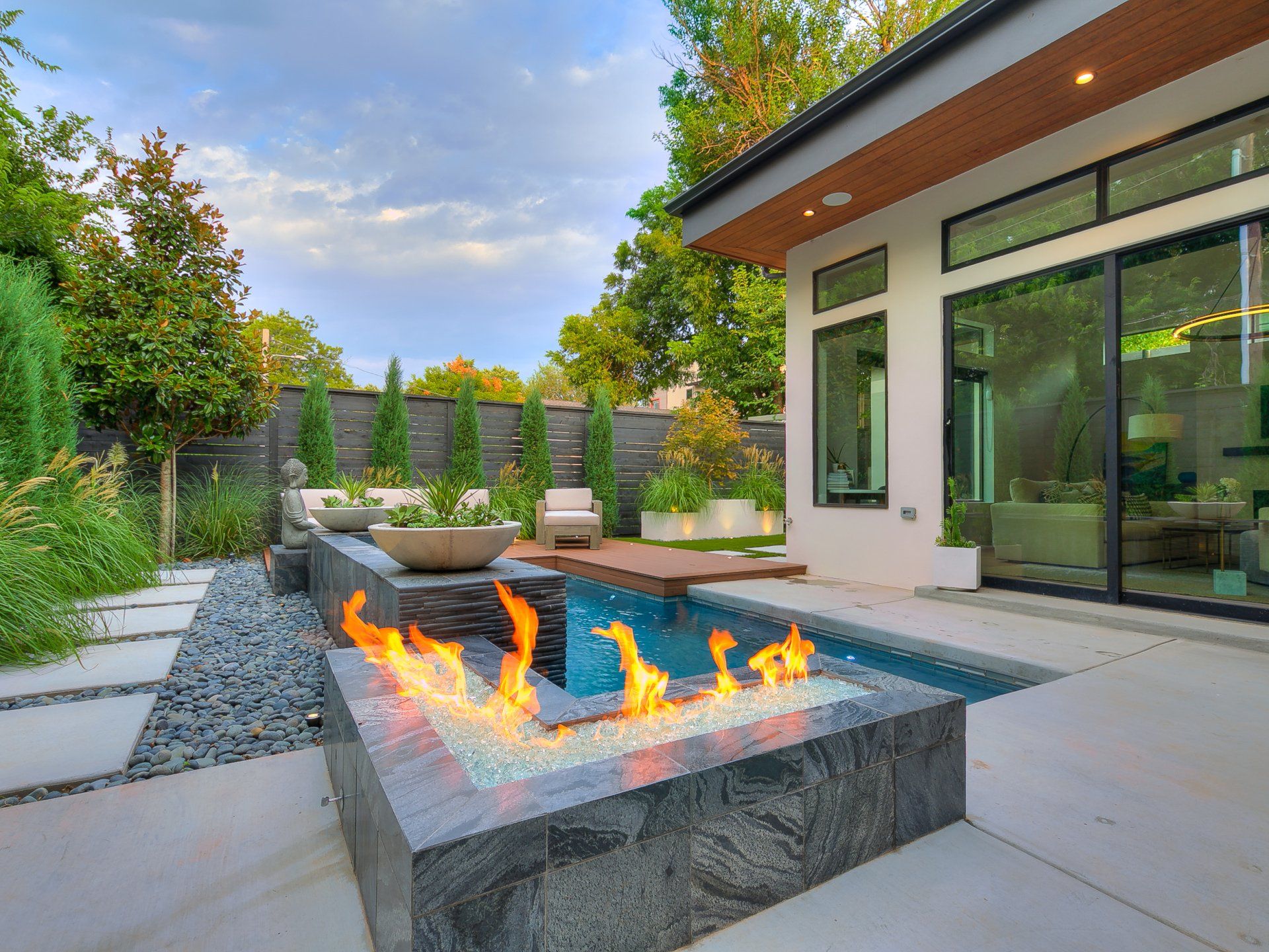 There is a fire pit in the middle of the backyard.