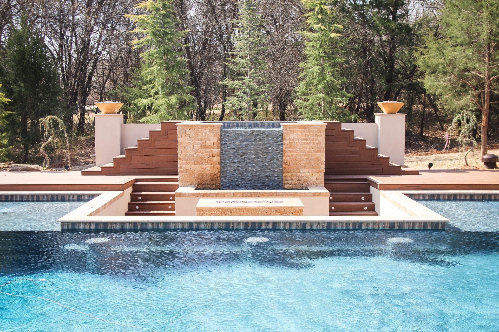 A large swimming pool with a waterfall in the middle