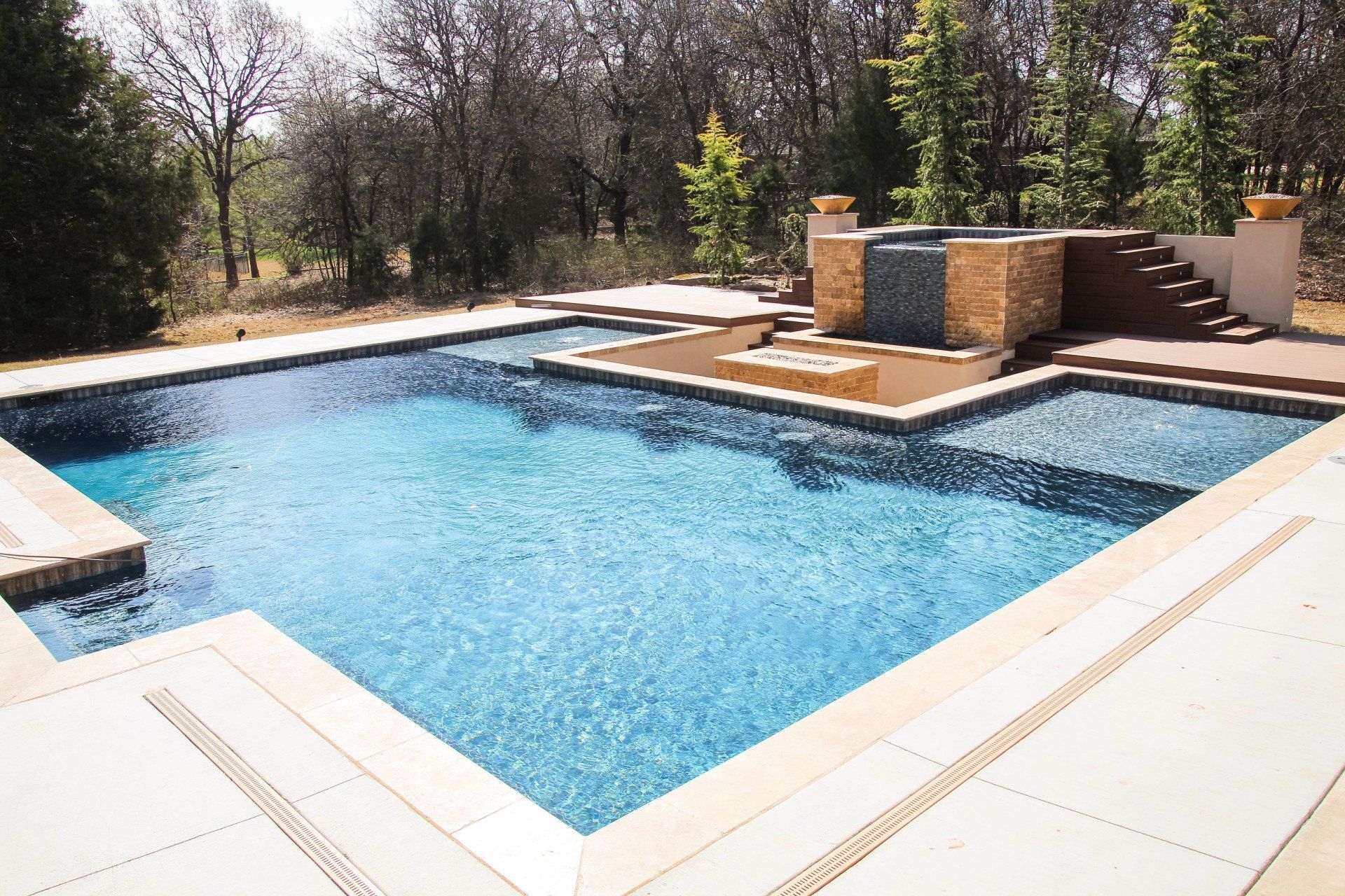 A large swimming pool with a waterfall in the background