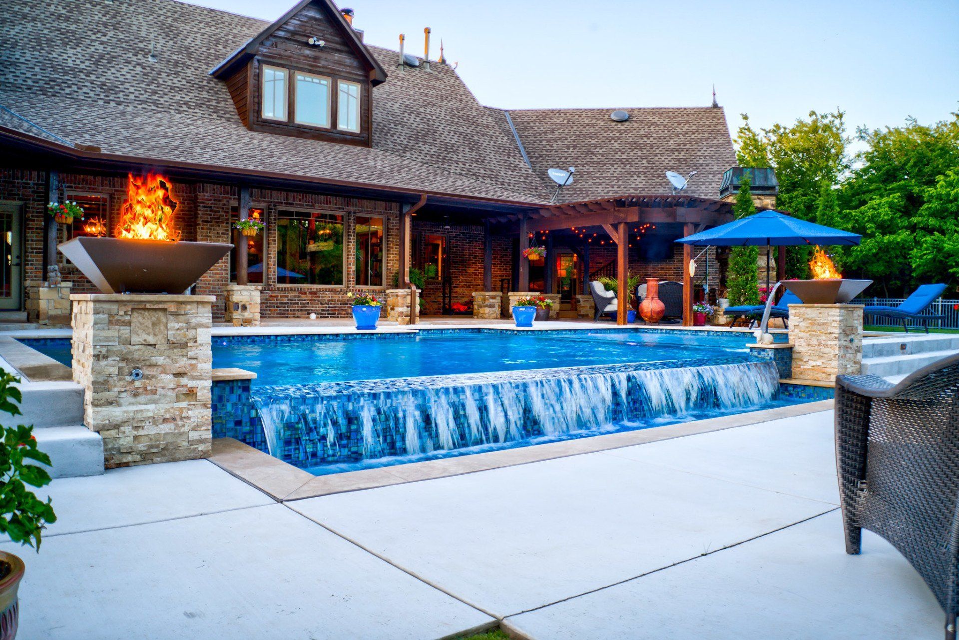 A large house with a large swimming pool in front of it.