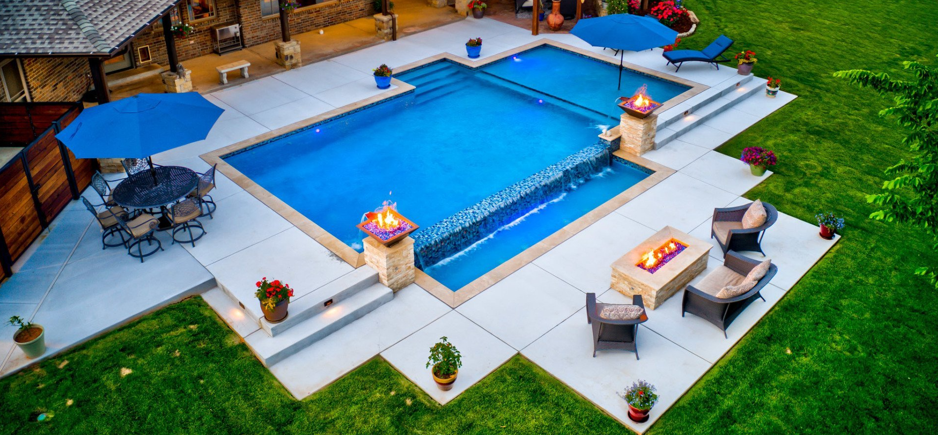 An aerial view of a large swimming pool in a backyard.