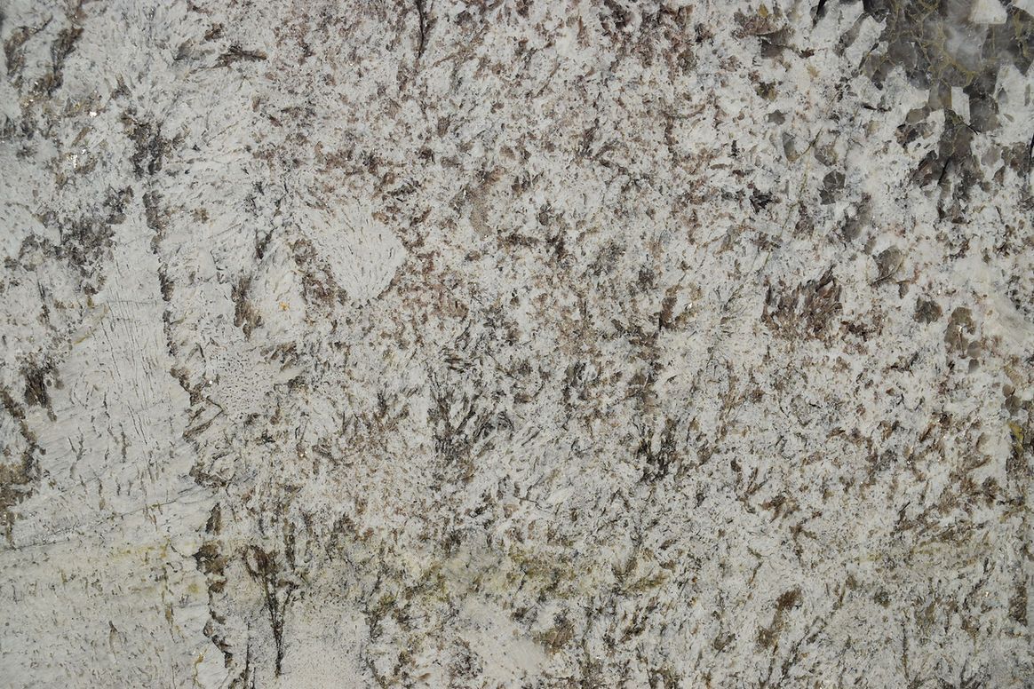 A close up of a white granite counter top.