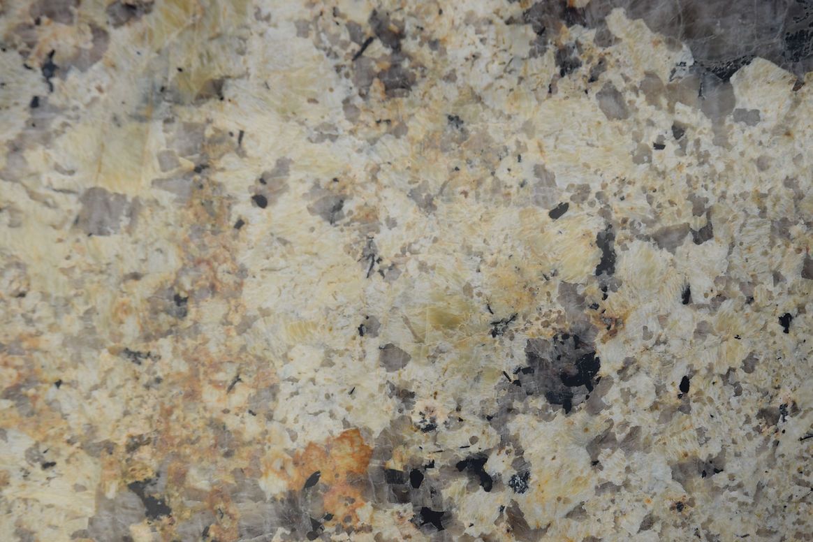A close up of a granite counter top with a marble texture.