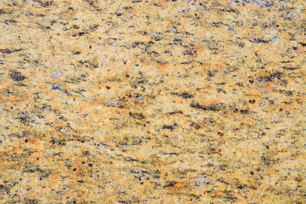 A close up of a yellow granite counter top.