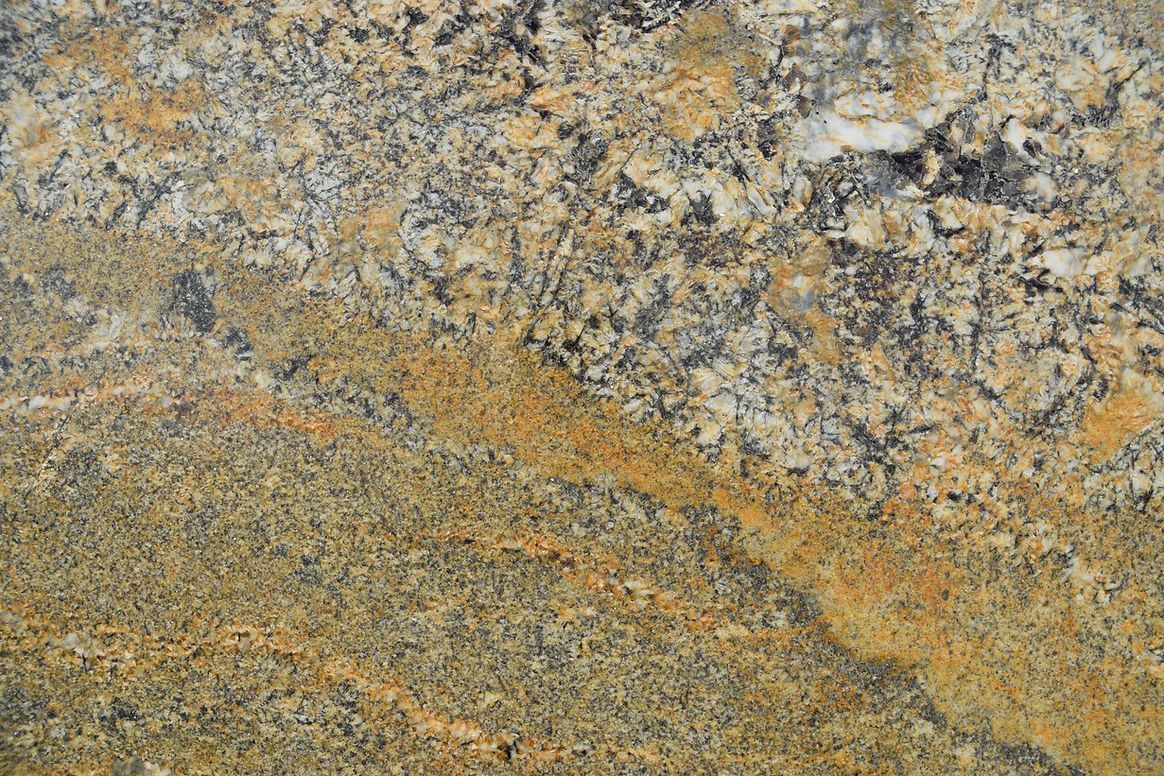 A close up of a yellow granite counter top.