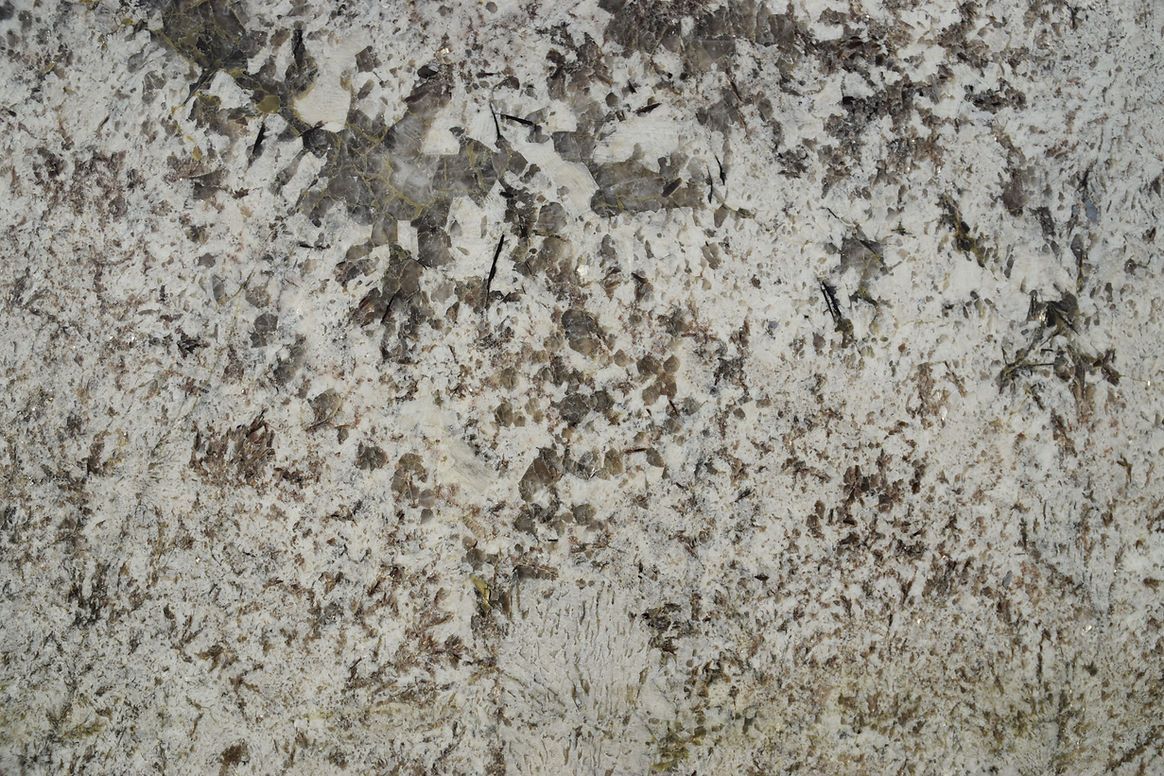 A close up of a concrete wall with a lot of small holes in it.