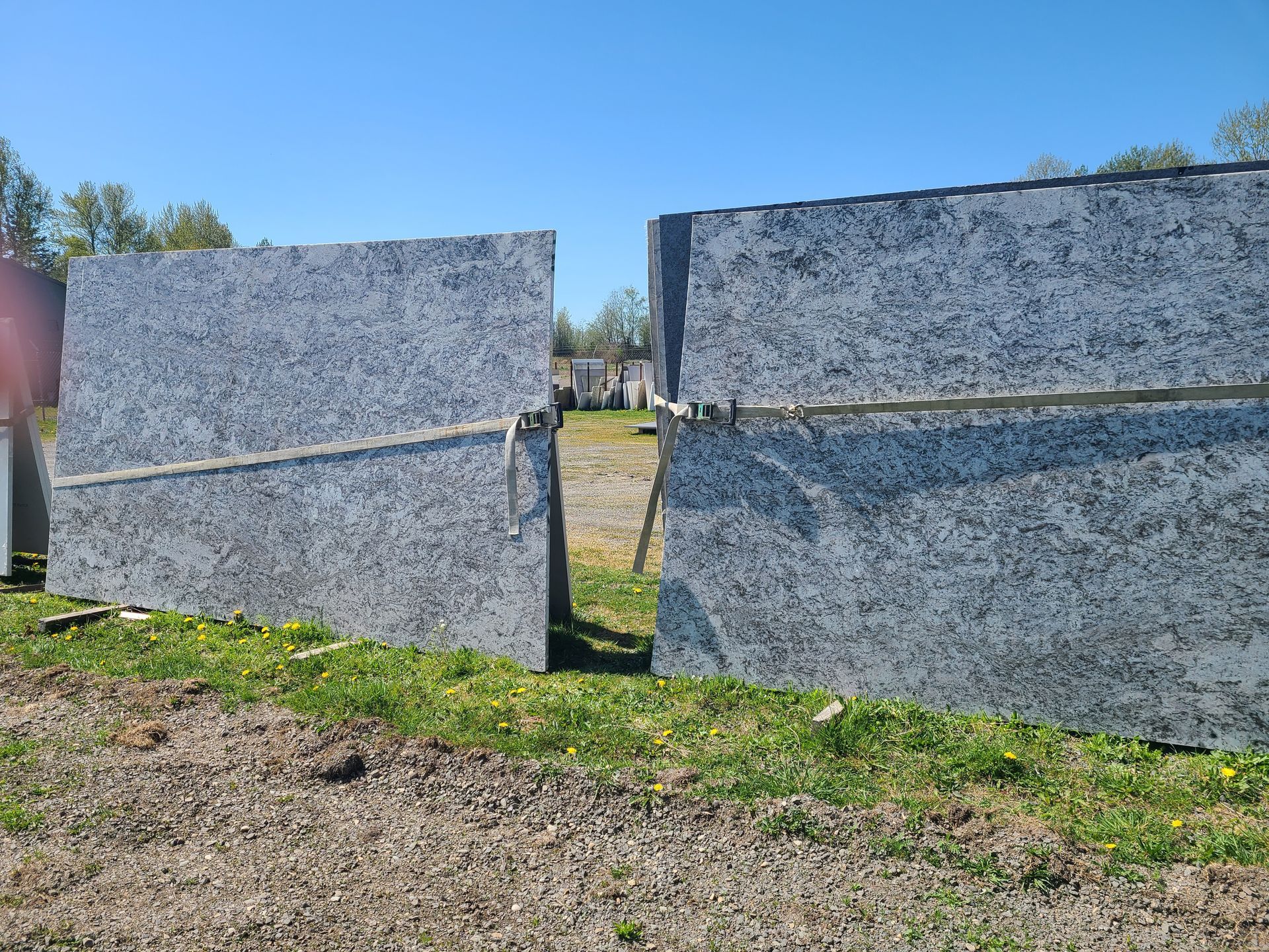 Two pieces of granite are sitting on top of each other in a field.