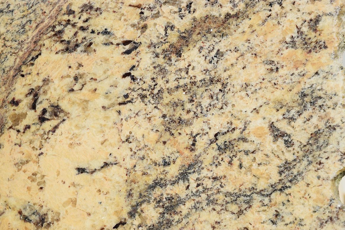 A close up of a granite counter top with a marble texture.