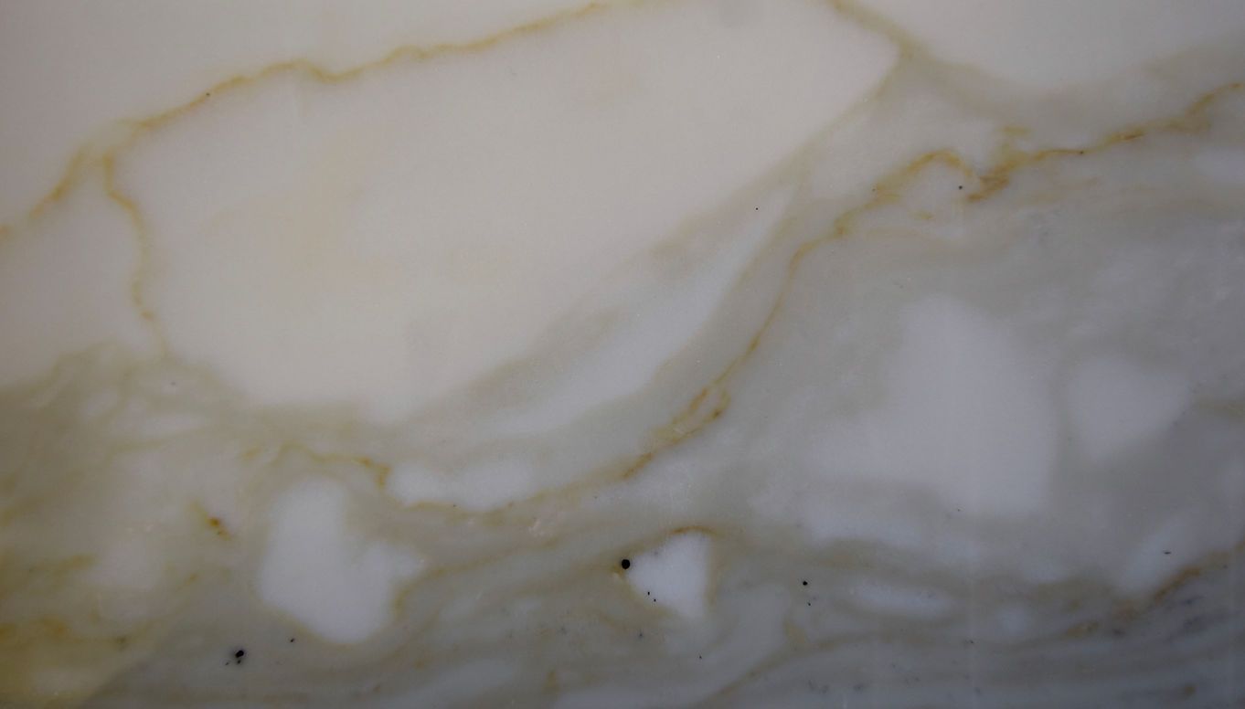 A close up of a white surface with brown stains on it.