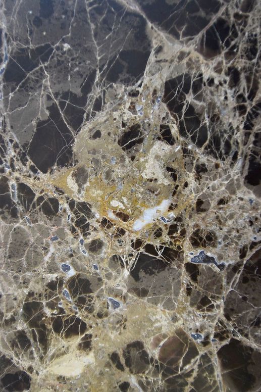 A close up of a black and gold marble texture.