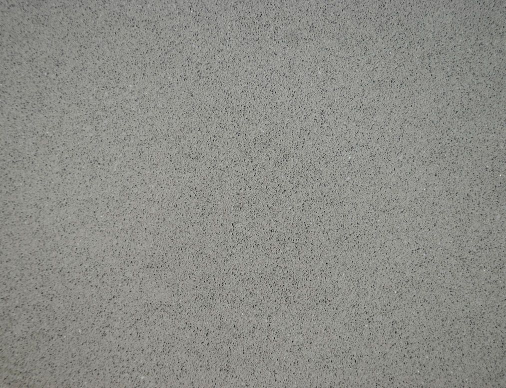 A close up of a gray surface with small dots on it