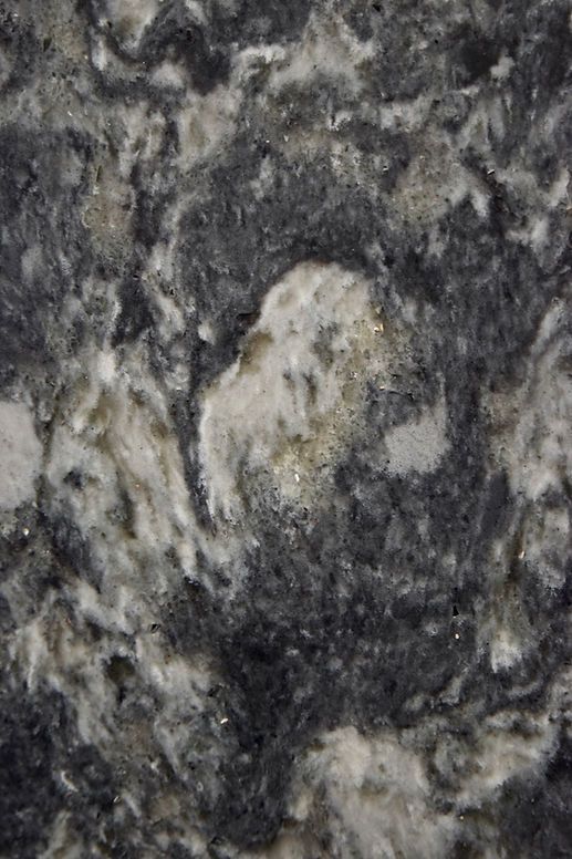 A close up of a black and white granite counter top.