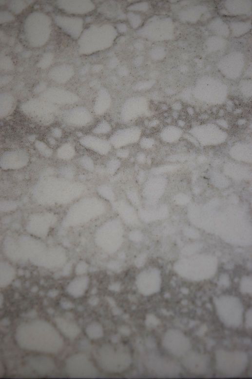 A close up of a white marble counter top.