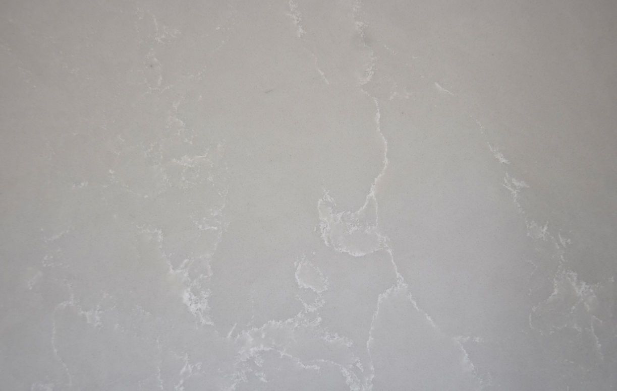 A close up of a white wall with a marble texture.