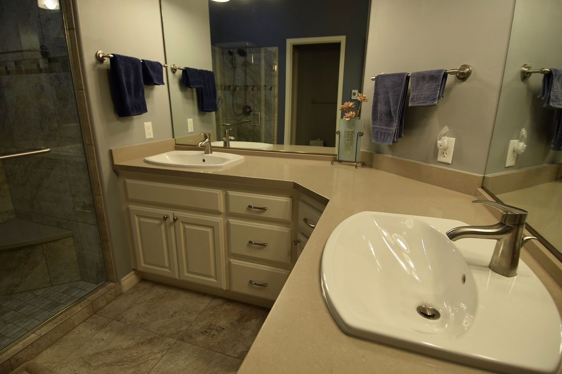 A bathroom with two sinks and a large mirror
