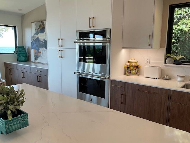 A kitchen with stainless steel appliances and white cabinets