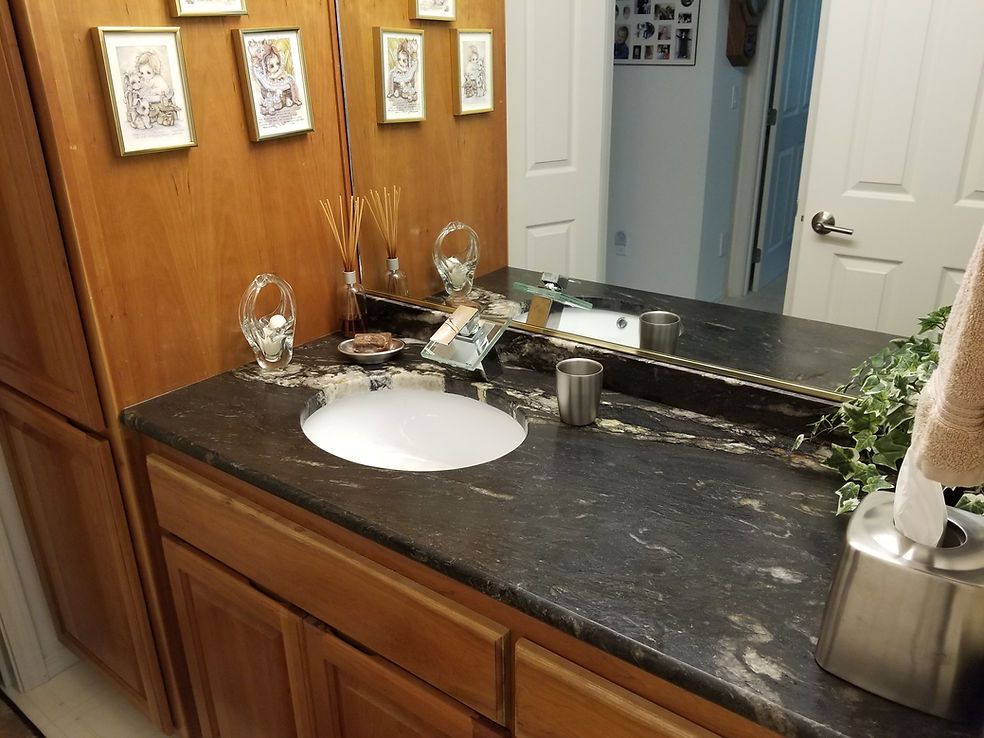 A bathroom with a sink and a large mirror