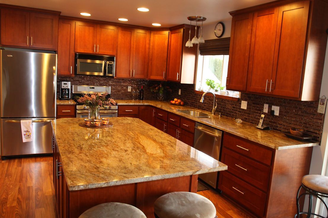 A kitchen with stainless steel appliances and granite counter tops