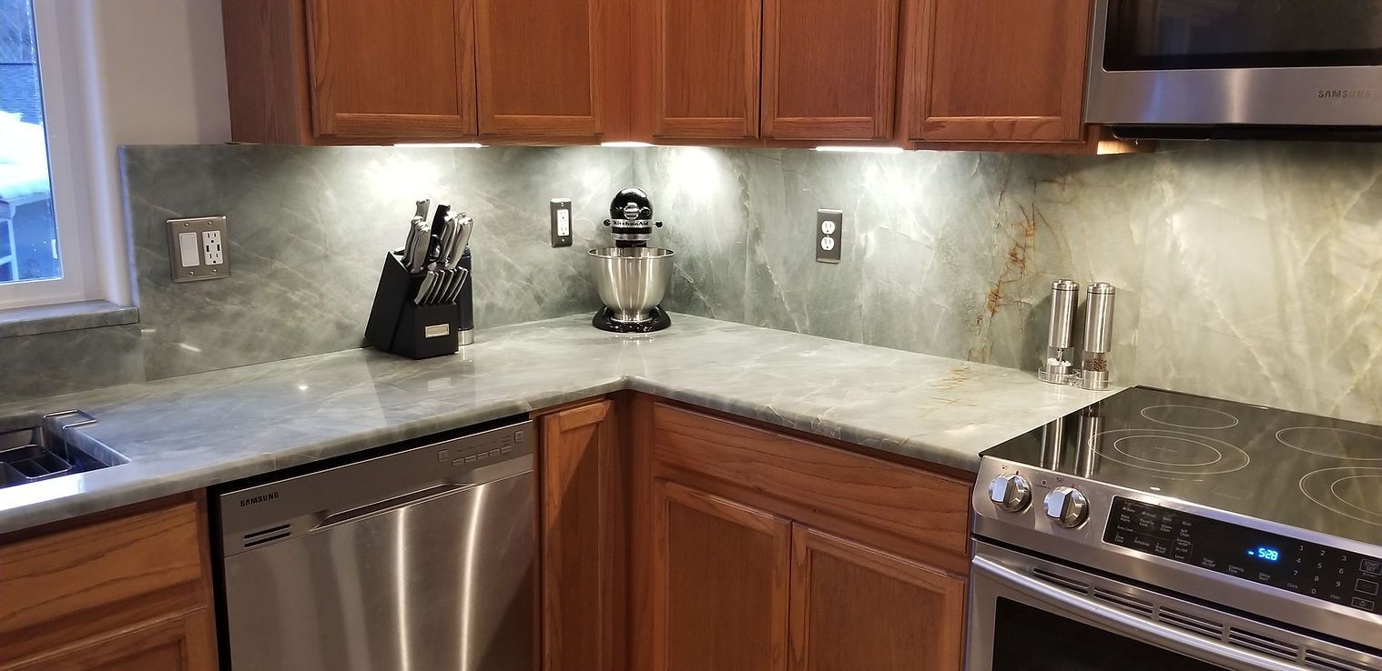 A kitchen with stainless steel appliances and wooden cabinets.