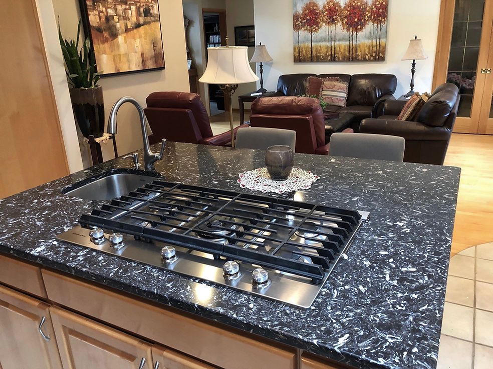 A kitchen with a stove top oven and a sink
