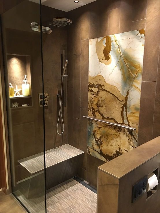 A bathroom with a walk in shower and a bench.