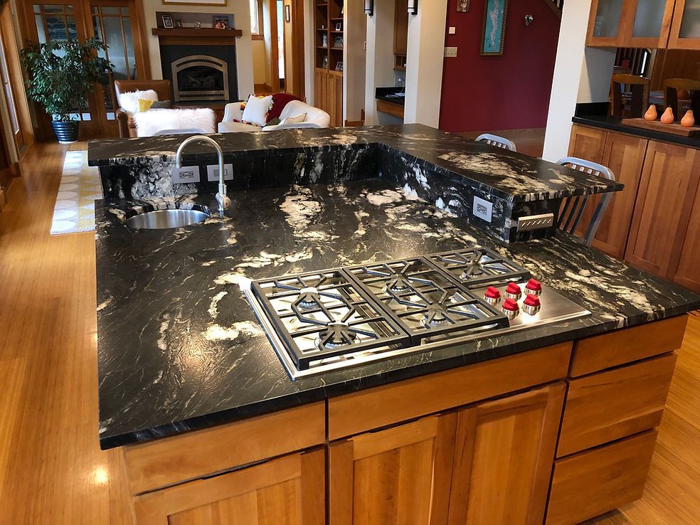 A kitchen with a stove top oven and a sink