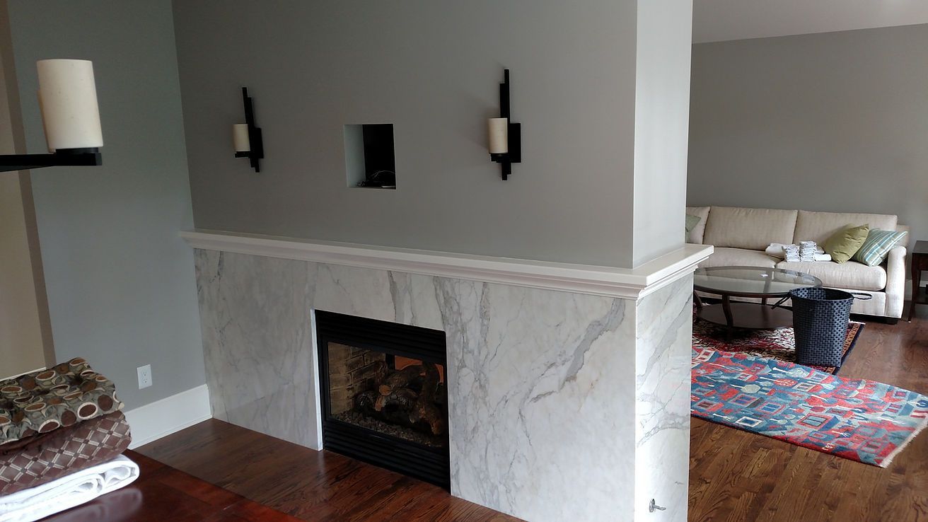 A living room with a fireplace and a couch.