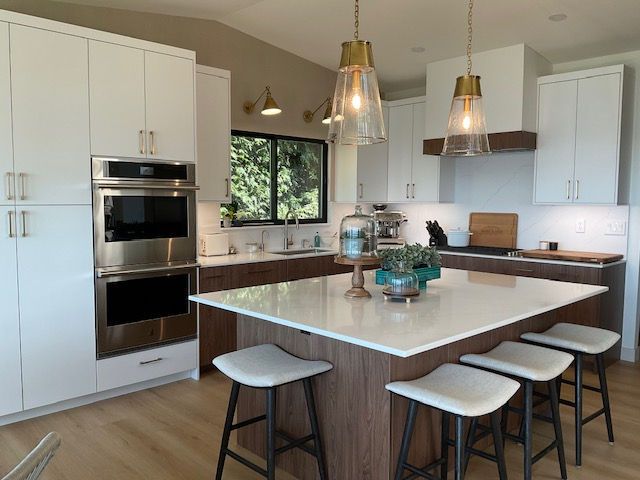 A kitchen with a large island and stools