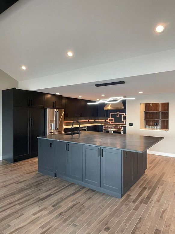 There is a large island in the middle of the kitchen.