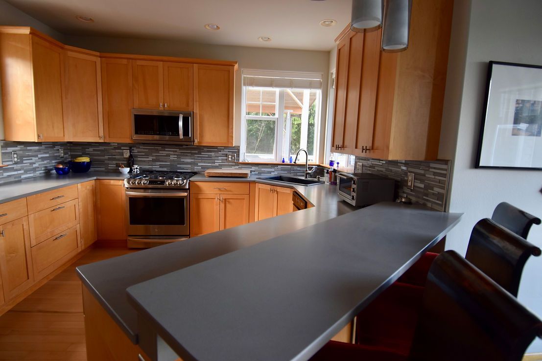 A kitchen with wooden cabinets and stainless steel appliances