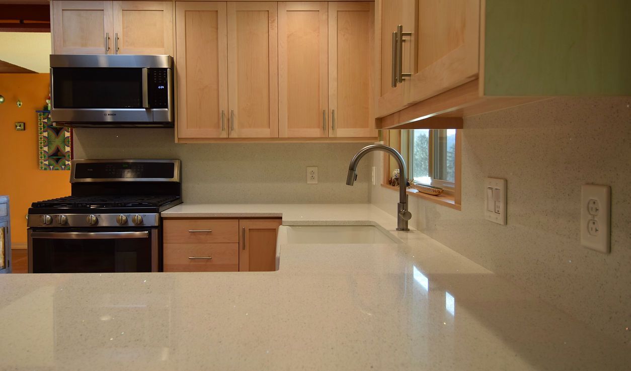 A kitchen with stainless steel appliances and wooden cabinets