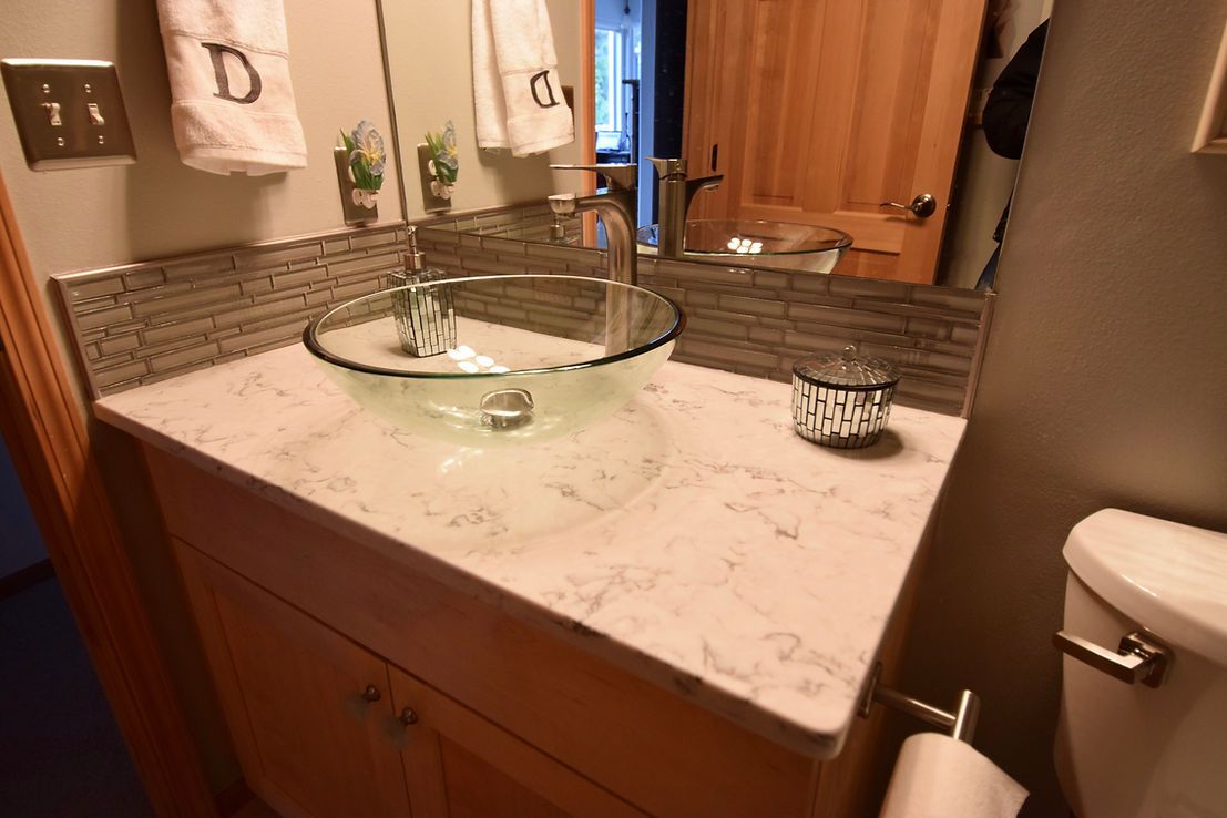 A bathroom with a sink , toilet and mirror.